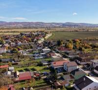 Aerial view of family houses on Južná Street in Veľké Orvište with picturesque countryside.