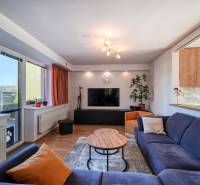 Living room in a family house, comfortable sofa, table and television, floor with wooden decor.