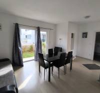 Living room with a black dining table and a wooden decor floor in a 3-room apartment.