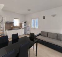 A kitchen in a 3-room apartment with a wooden decor floor, spiral staircase.