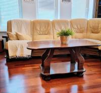 A comfortable sofa set and a table on a floor with a wooden decor in a family house.