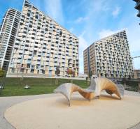 Buildings with modern design on Bottova Street in Bratislava with an original bench in the foreground.