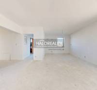 A spacious room with white walls in a family house, ready for renovations.