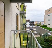 A balcony with a view of modern buildings on Tupého Street in Bratislava - Nové Mesto.