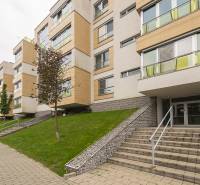 Apartment building on Tupého Street in Bratislava - Nové Mesto with greenery and a walkway.