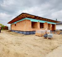 Construction site of a family house in Bernolákovo with an unfinished roof and building materials.