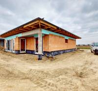 Family house under construction in Bernolákovo on undeveloped land with parking.
