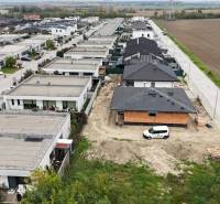 Residential housing area in Bernolákovo, surrounded by fields and paved roads.