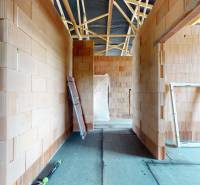 The interior of a family house with unfinished brick walls.