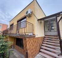 A family house on Jilemnického Street in Dvory nad Žitavou with external stairs and a balcony.
