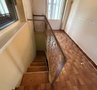Hallway with ceramic flooring and staircase in a family house.