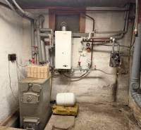 Boiler room in a family house with pipes and a boiler.