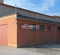 Commercial premises in Čakajovce, a single-story building with an orange facade and a flat roof.