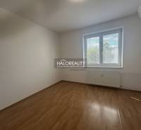 A room in a 3-room apartment with a wooden decor floor and a large window.