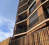 Apartment building in Bratislava-Petržalka with a brick facade and modern balconies.