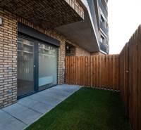 A terrace with paving and a lawn at a 1-room apartment in Bratislava - Petržalka.