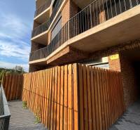 Apartment complex with a brick facade and a wooden fence in Bratislava - Petržalka.