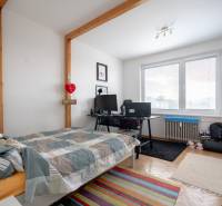 A bedroom with a desk and a decorated floor in a 3-room apartment.