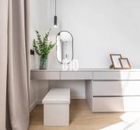 Interior detail of a 3-room apartment with a vanity table, mirror, and decorations.