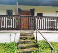 Stone steps leading to the cottage in Chocholná-Velčice with a wooden railing.