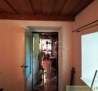 Interior of a cabin with access to another room; floor with wooden decor.