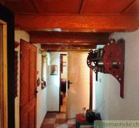 Interior of a cabin with wooden decor, decorative wall element, and doors.