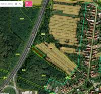 Aerial view of commercial land in Čaradice by the main road and fields.