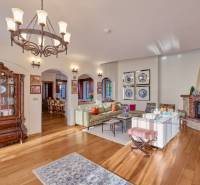 Living room in the villa with wood-patterned flooring and stylish lighting.