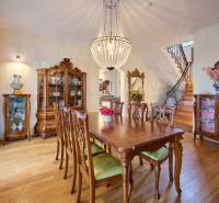 Dining room in the villa with stylish furniture and wooden decor flooring.