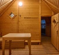 The interior of a villa with wooden decor, a table, and a bench, reminiscent of a sauna.