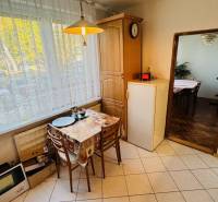 Kitchen in a 3-room apartment with a dining table and a view of the street.