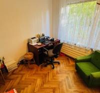 A room in a 3-room apartment with a desk and a floor with a wooden decor.