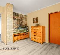 Family house with a wooden dresser, an aquarium, and a floor with a wooden decor.