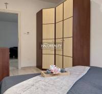 A bedroom in a 3-room apartment with a large wardrobe and bed, wood decor.