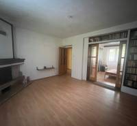 Living room in a family house with a fireplace and a floor with a wooden decor.