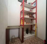A pantry in a family house with a shelf for storing food and drinks.