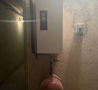 Boiler with a pressure tank in the utility room of a family house.