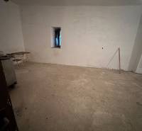 Empty room in a family house with a simple window and a chair.