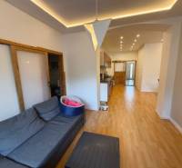 Living room in a family house with a sofa and a wooden decor floor.