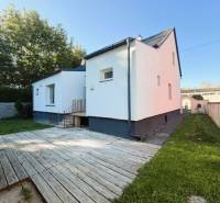 Family house on Industriestraße in Hainburg an der Donau with a wooden terrace.