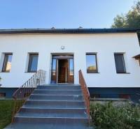 Family house on Industriestraße in Hainburg an der Donau, with a white facade and a staircase.