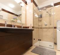 Bathroom with a sink, shower, and washing machine in a 3-room apartment.