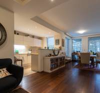 3-room apartment with wood-patterned flooring and a kitchen connected to the dining area.