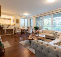 Living room in a 3-room apartment with a sofa, table, and wooden decor flooring.
