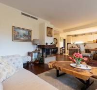 A stylish living space with a sofa, floral decoration, and furniture in a 3-room apartment.