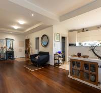 Living area of a 3-room apartment with a wooden decor floor and stylish furniture.