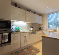 Corner kitchen unit in a 3-room apartment with built-in appliances and a large window.