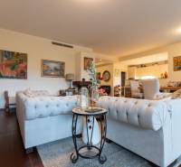 Living room in a 3-room apartment with sofas, armchairs, and a wooden decor floor.