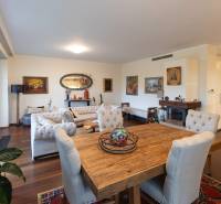 Living room in a three-room apartment with a wooden decor floor and stylish furniture.