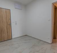 Hallway with tiles and doors in a 3-room apartment.